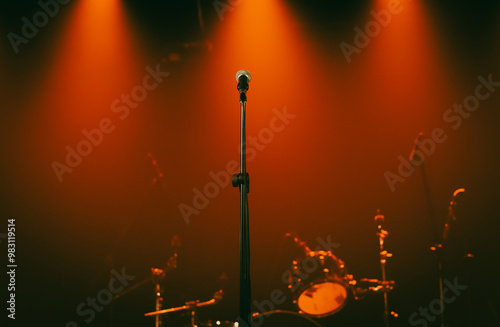 Background - microphone on stage against red spotlights, no people