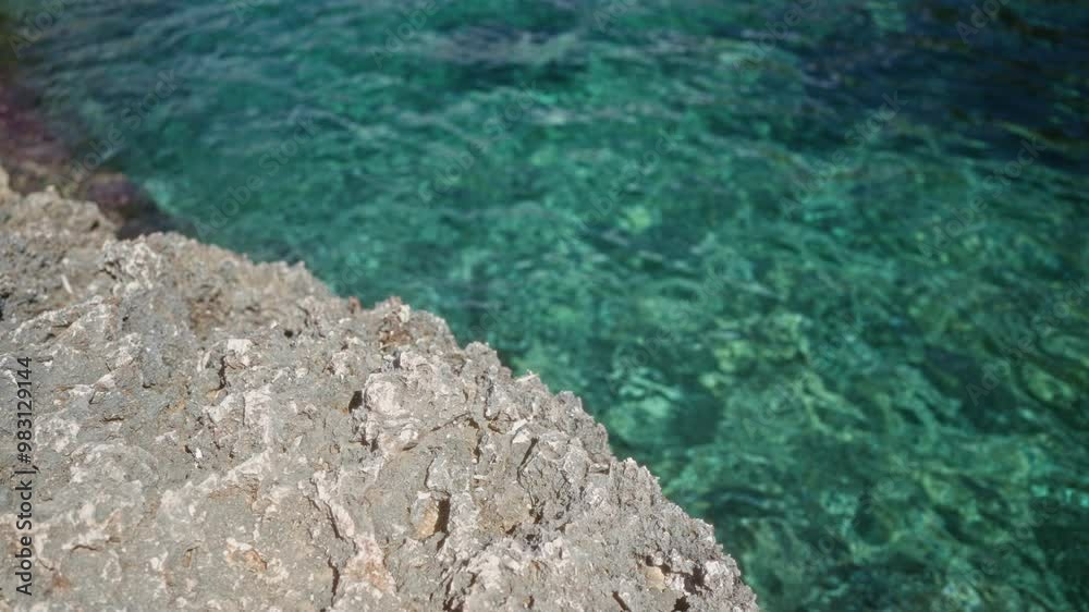 Turquoise water contrasts with rugged rocks along the coastline in mallorca, spain, showing the beauty of mediterranean nature. Turquoise water contrasts with rugged rocks along the coastline in mallorca, spain, showing the beauty of mediterranean nature.