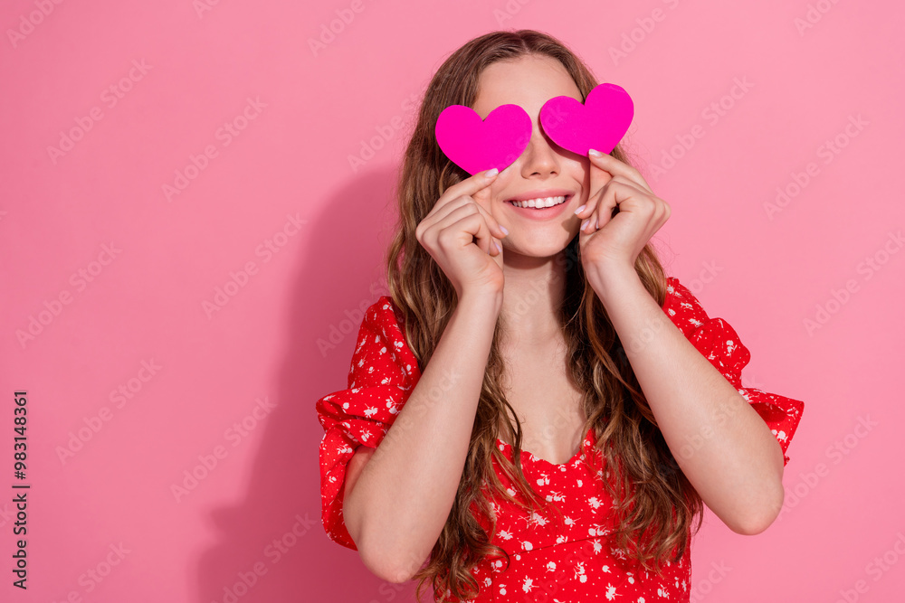 Photo portrait of attractive teen woman hide cover eyes heart postcards dressed stylish red clothes isolated on pink color background Photo portrait of attractive teen woman hide cover eyes heart postcards dressed stylish red clothes isolated on pink color background