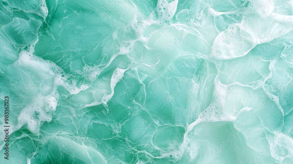 Fototapeta premium A tight shot of a green-white marbled wallpaper, adorned with white whorls at its upper and lower edges