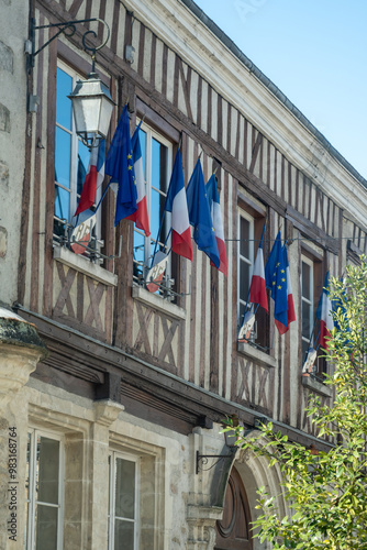 Driving in Champagne wine making region in Champagne, France. Streets, house decorated with french flags, summertime photo