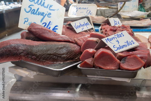 Assortment of fresh ocean daily catch of different tuna, cazon, sharks, fish, prawns, seashells, molluscs on ice on fish market in Jerez de la Frontera, Andalusia, Spain photo