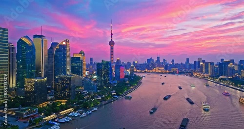 Aerial shot of modern city buildings skyline and river at sunset in Shanghai