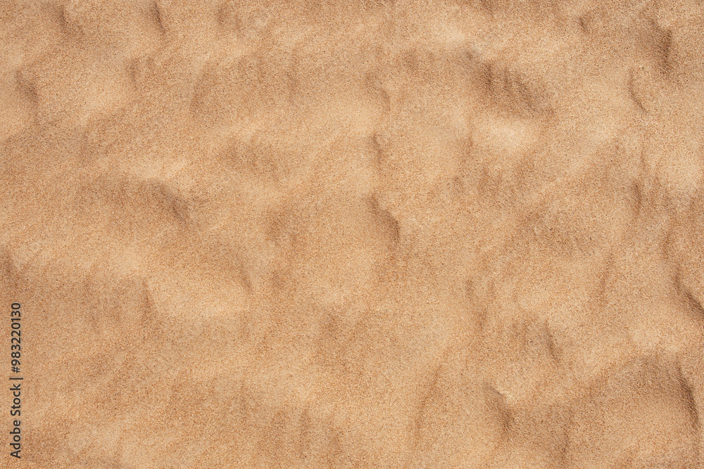 The undulating texture of sand on the seashore