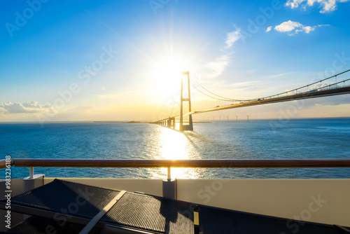 Photography View of the setting sun over the Öresund Bridge which spans the strait between Sweden and Denmark on the Baltic Sea