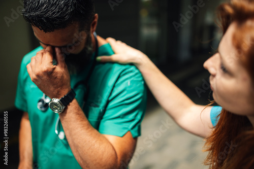 Medical professional being comforted by a colleague with empathy