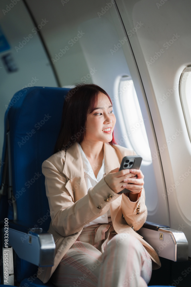 Window Seat Wanderlust: A young businesswoman embraces the journey, her gaze lost in the clouds as she connects with the world from her airplane seat.