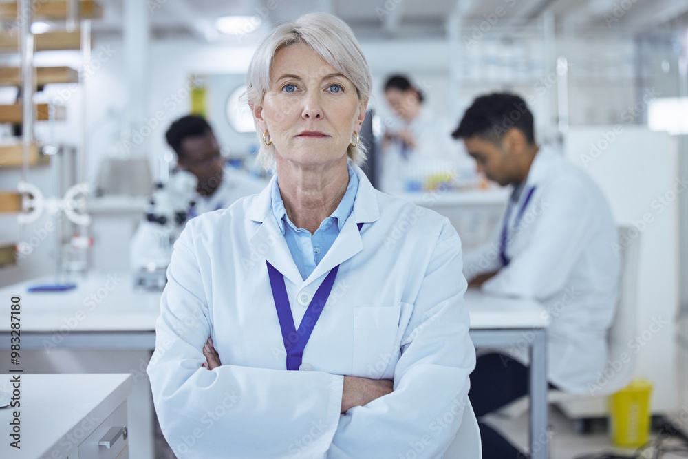 Fototapeta premium Portrait, mature woman and arms crossed in lab, scientist and serious for science, confident and healthcare. Proud, medical research and process for medicine, person and cure for mpox in Denmark
