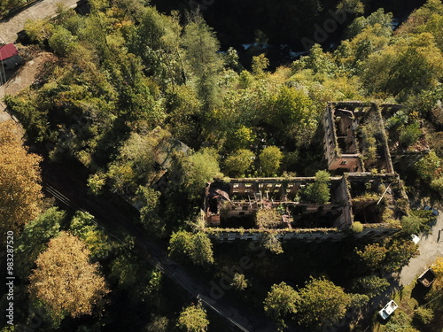 Aerial photos. A shot above an abandoned house in the mountains of Abkhazia in Akarmara. Stone walls and windows without glass, the wall is destroyed, and the area around