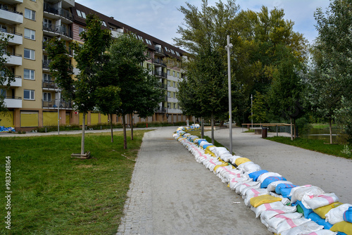 Bags of walking next to the house. Flood protection. Threat of flooding by the river. Wroclaw, Poland September 2024