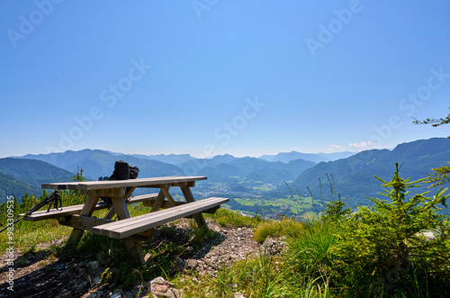 A bench on the hilltop with a panoramic view of the mountains. Austrian Alps. 