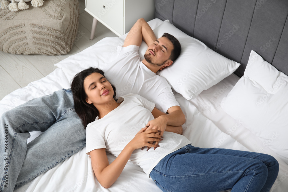 Loving young couple sleeping on bed at home Loving young couple sleeping on bed at home