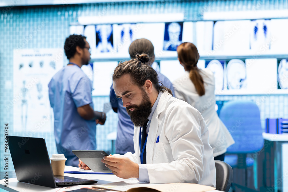 Fototapeta premium Professional medical team examine hospital records and treatment outcomes in a clinic to ensure quality insurance services. Physician specialist analyzing test results for expert solutions.