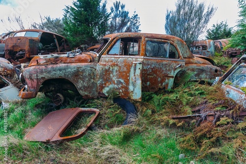 Abandoned and rusted classic cars  in the The historical Horopito Motor Wreckers - Smash Palace, near Raetihi, Manawatu-Wanganui, New Zealand. photo