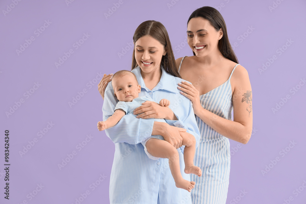Young lesbian couple with their little baby on lilac background Young lesbian couple with their little baby on lilac background