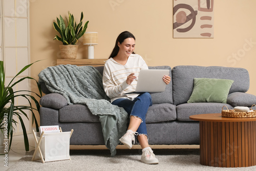 Young woman using laptop on...