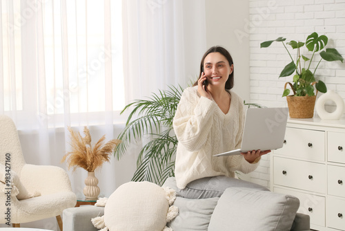 Young woman with laptop tal...