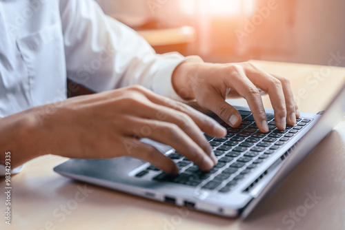 Businessman hand typing on computer keyboard of a laptop computer in office. Business and finance concept. uds