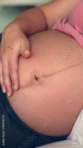 Wallpaper Mural Pregnant woman feeling happy at home while taking care of her child. The young expecting mother holding baby in pregnant belly. Maternity prenatal care and woman pregnancy concept. Torontodigital.ca