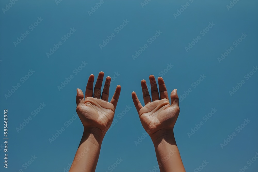 A pair of hands raised toward the sky, A pair of hands raised toward the sky,