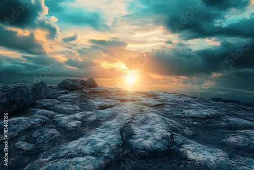 Dramatic Sunset Over Rocky Landscape with Cloudy Sky