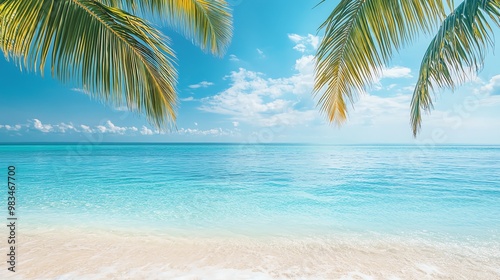 Tropical beach scene with clear blue water and palm trees.