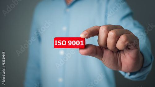 ISO 9001 Standard certification standardisation quality control concept, Businessman showing the ISO 9001 icons for certified and quality management of organizations. photo