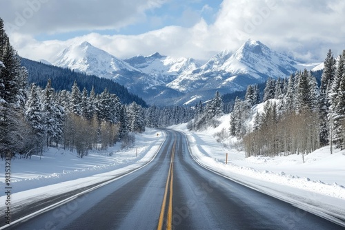 A serene winter road winding through snow-covered mountains and pine trees under a bright sky.