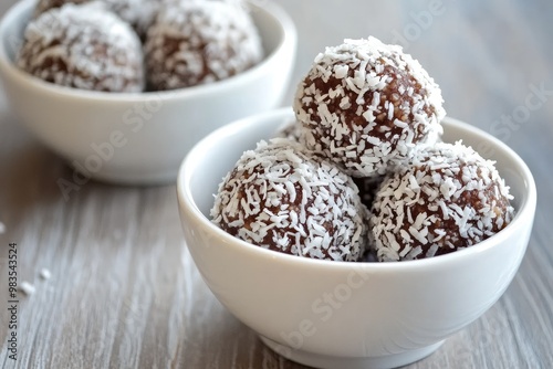 Delicious coconut-covered chocolate balls served in white bowls, perfect for dessert lovers and delightful treats.