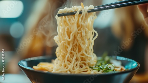 Steaming Bowl of Savory Asian Noodles with Chopsticks photo