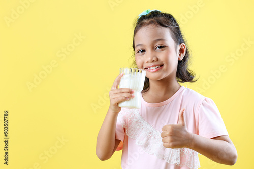 Cheerful Little Asian Girl Drinking Milk.