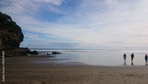 Beachcombers on Piha Beach in Auckland New Zealand Photo photo