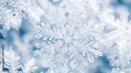 A close-up of a delicate snowflake showcasing intricate patterns and textures against a soft blue background.