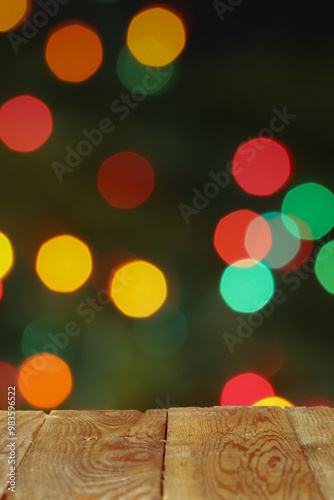 Empty wooden table in front of blurred christmas lights background photo