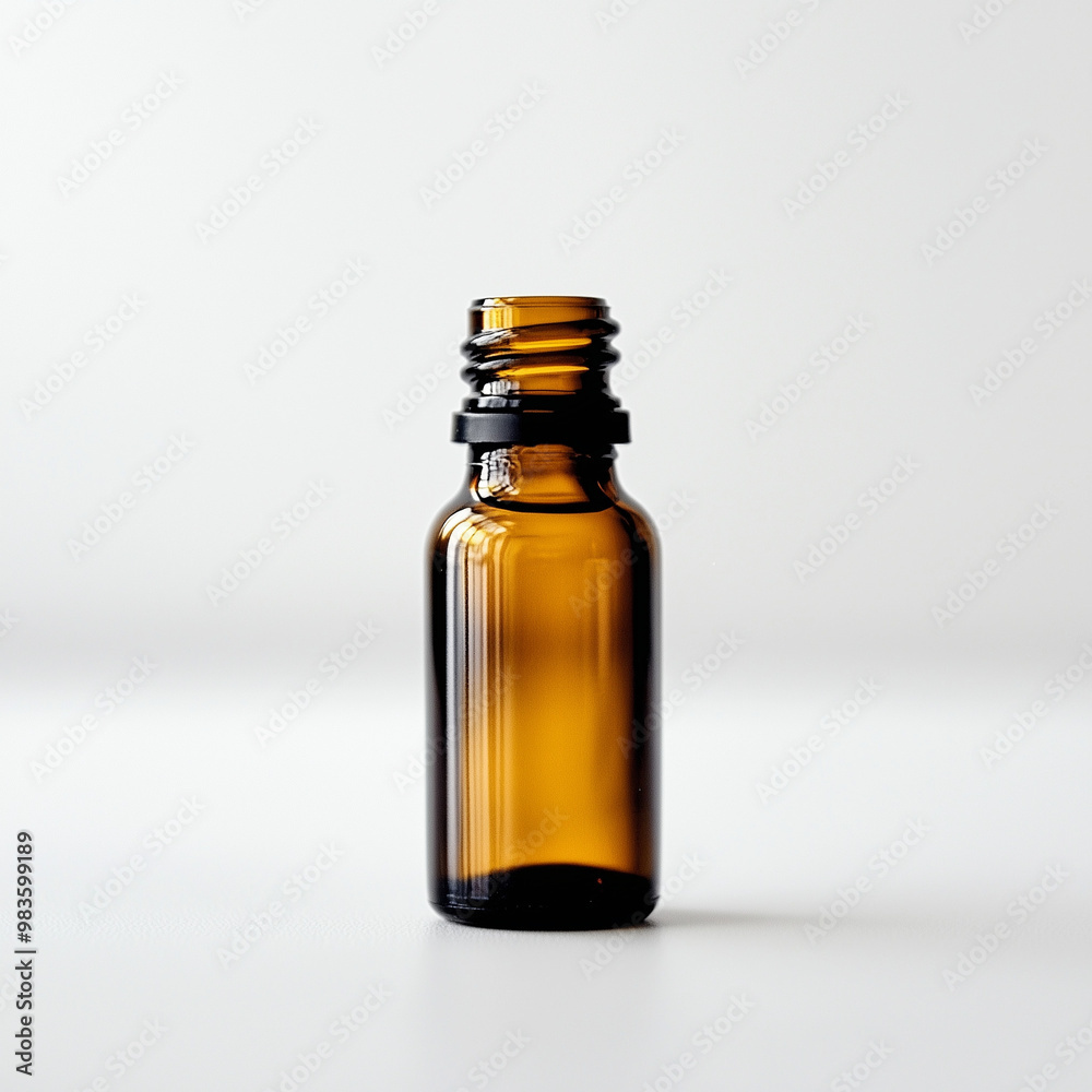 Small Bottle of Essential Oil with Cap: Pure Aroma on White Background Small Bottle of Essential Oil with Cap: Pure Aroma on White Background