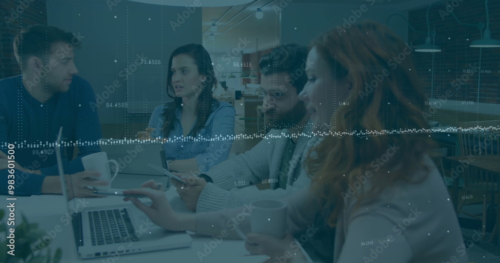 Fototapeta premium Financial data processing image over diverse business people working on laptops