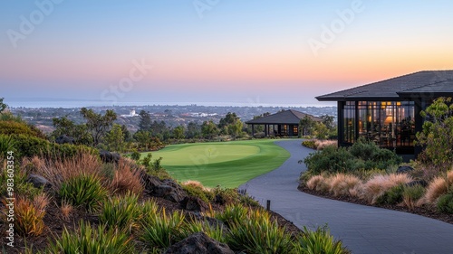 Stunning sunset view over a golf course with lush greenery and modern architecture, perfect for leisure and relaxation.