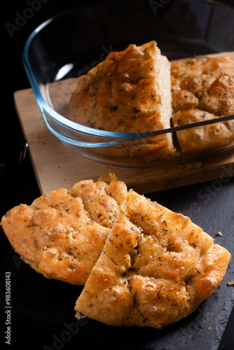 food concept homemade focaccia on black background with copy space