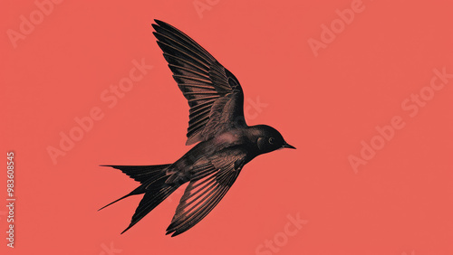 A black bird flying across a stark red sky, with branches silhouetted against the vibrant background. photo