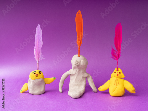Children and adults make shapes and sculptures with play dough and draw pictures.