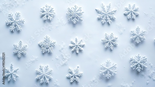 A mesmerizing arrangement of unique snowflakes on a pristine white background, showcasing the beauty of winter's delicate patterns.