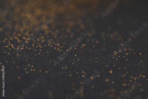 Beautiful shiny golden glitter on black background, closeup