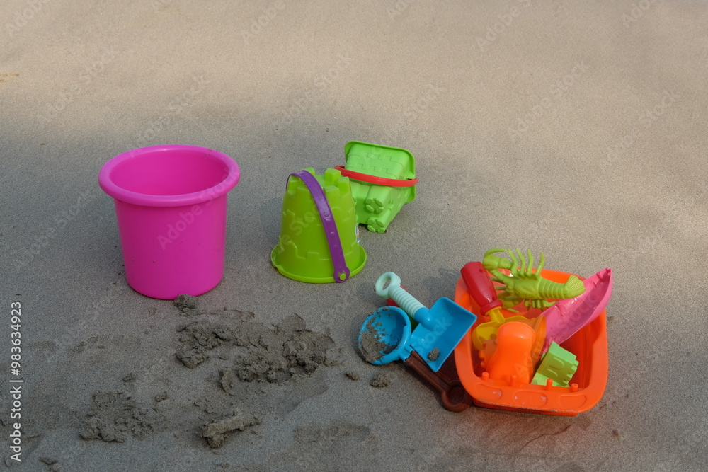 Set of colorful beach toys, bucket, castle, rake and shovel for children on the beach sand. Set of colorful beach toys, bucket, castle, rake and shovel for children on the beach sand.