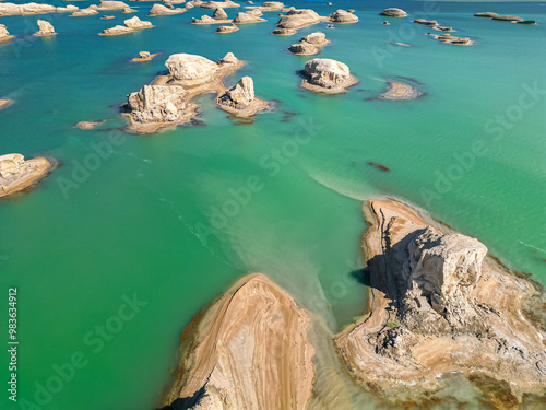 A scenic view of Wusute Yadan Geopark, with small rock formations on water in Qinghai, China photo