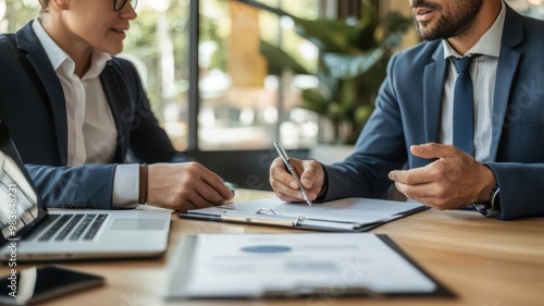 Bank representative explaining down payment requirements to a small business owner in a formal setting, loan counseling, financial guidance photo