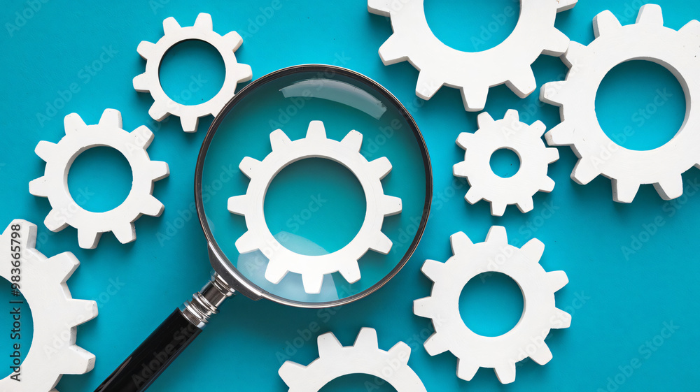 Magnifying glass and gears on blue background. Concept for search, research, and innovation. Magnifying glass and gears on blue background. Concept for search, research, and innovation.