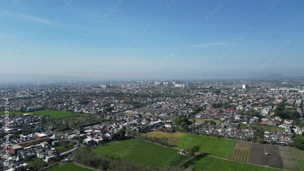 view from above is a view of residential areas in Malang city with several towering university buildings