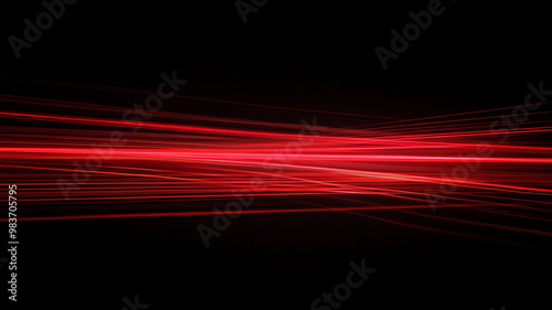 Bright red light streaks create a dynamic abstract pattern in a dark setting during nighttime