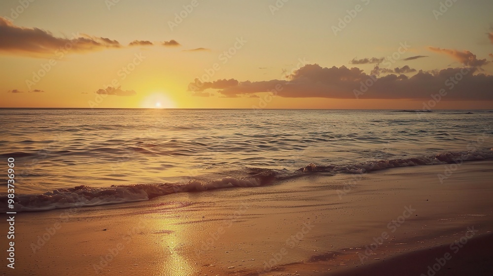 A beautiful beach under the natural sunset sky. The sand on the beach is golden, stretching out towards the ocean A beautiful beach under the natural sunset sky. The sand on the beach is golden, stretching out towards the ocean
