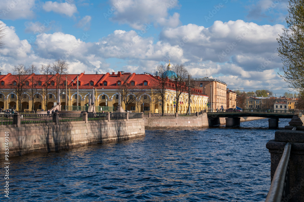 Obraz premium View of the Nikolsky Rows building on the Kryukov Canal embankment, Staro-Nikolsky and Krasnogvardeysky bridges on a sunny spring day, St. Petersburg, Russia